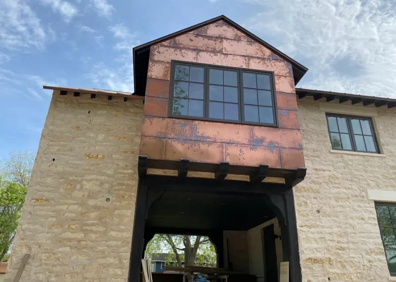 Copper metal panel facade on a stone building for Skylight Installation in Fultondale